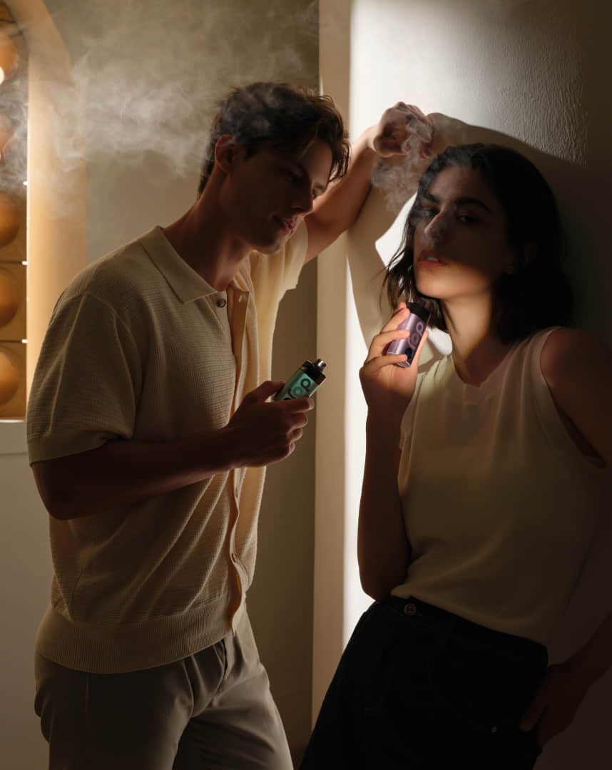 A man and girl hold vapor 